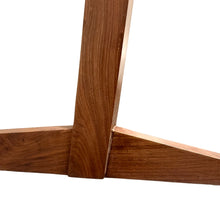 Load image into Gallery viewer, Detailed view of Conoid Chair legs showcasing cantilever design and wood texture.