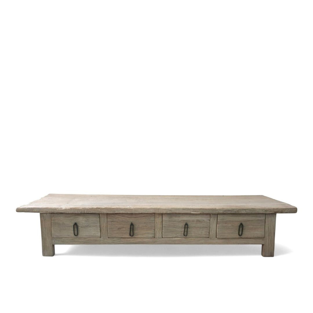 Solid old elm coffee table from Shandong with four front drawers and black metal pulls. Natural wood finish.