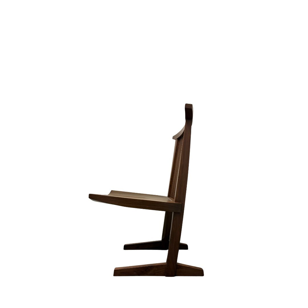 Side view of Conoid Chair showing elegant wooden curves, left profile.